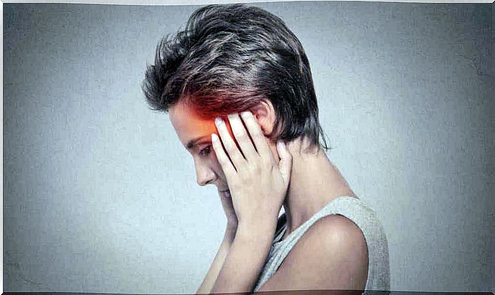 A woman's hands on her temples.