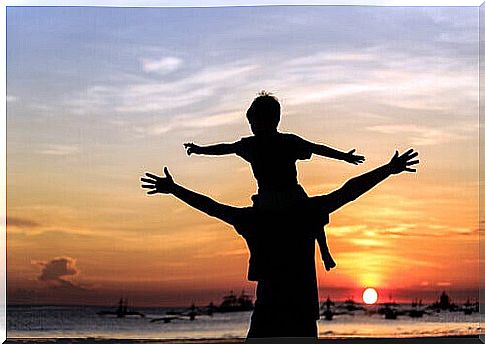 child-on-the-shoulders-of-his-father-at-the-beach