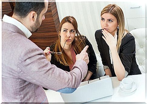 man chatting with two women