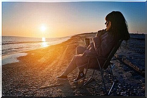 young woman on the beach taking distance