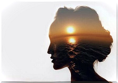 Head of a woman in profile with a picture of a sunset transparent in her brain. 